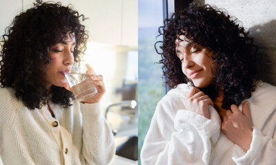 A woman with curly hair enjoys a glass of water in a bright kitchen, followed by a moment of relaxation in a cozy robe.