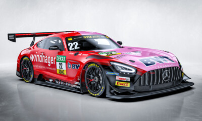 A Mercedes-AMG GT3 race car featuring a striking red livery with prominent sponsor logos including Windhager and BWT.
