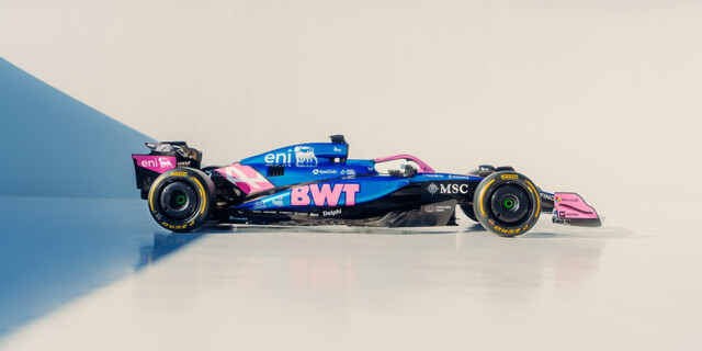 A dynamic side profile of a BWT-branded Formula 1 racing car features vibrant blue and pink livery.